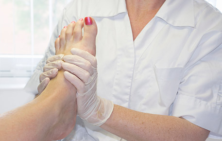 A Doctor Examining The Foot of a Patient